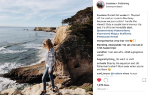 Image of a screen shot with blonde woman walking along a rocky shoreline. Comments from truelane on the right.